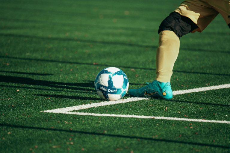 A person's foot rests near a football