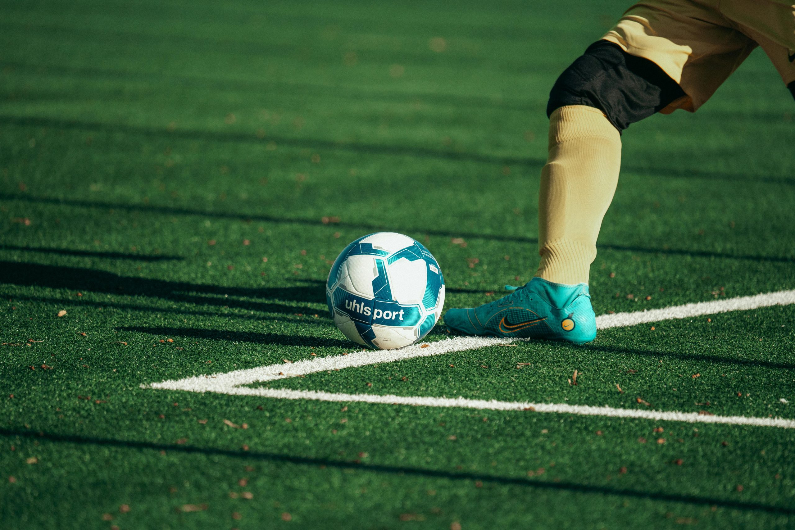 A person's foot rests near a football
