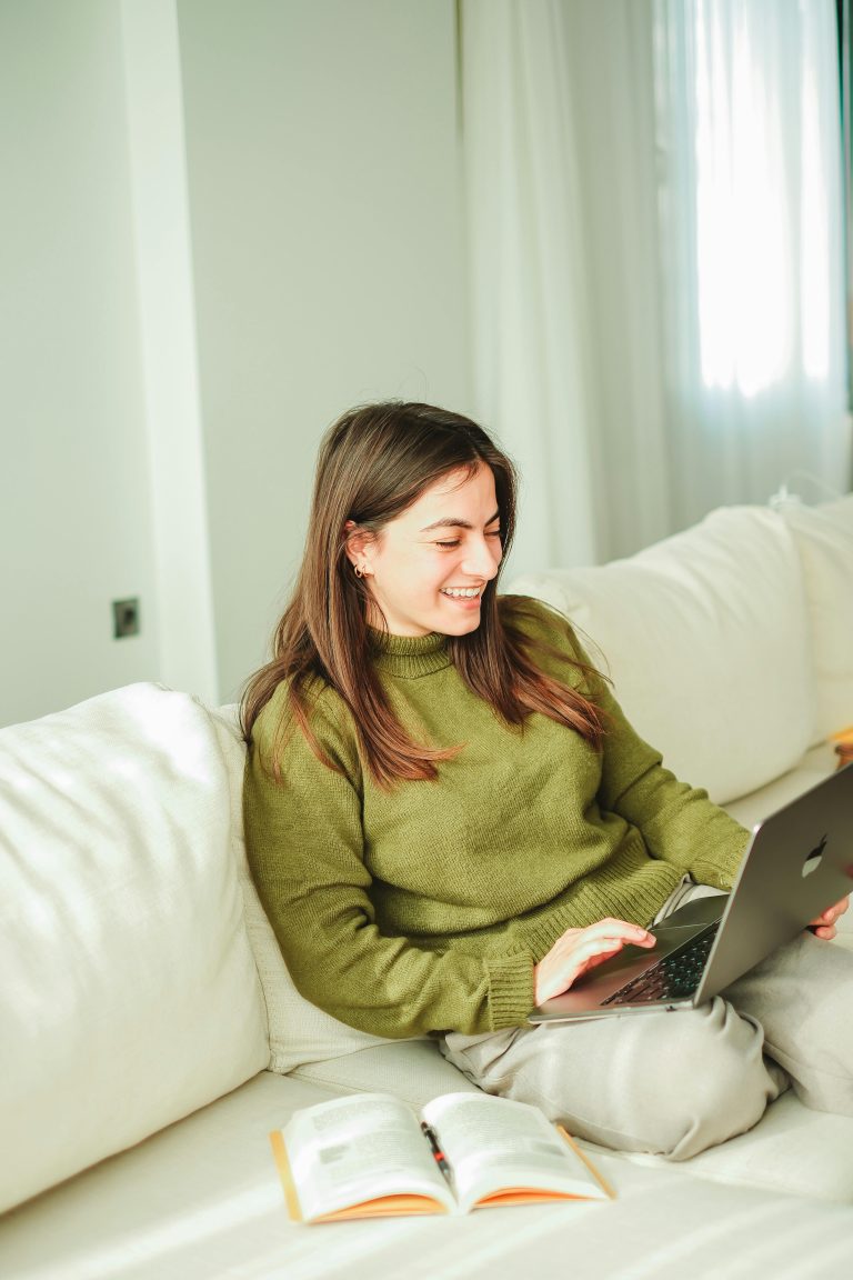 Smiling woman sitting on sofa