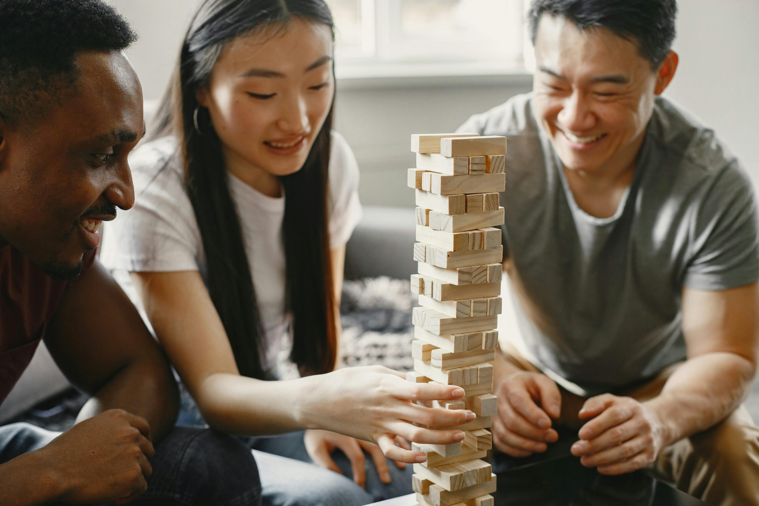 A group of friends play Jenga