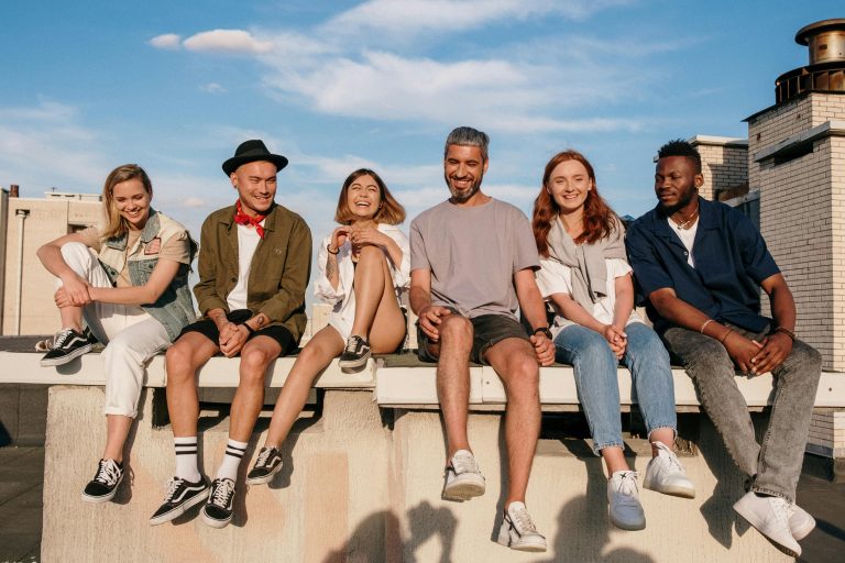 Group of people sitting on a concrete bench