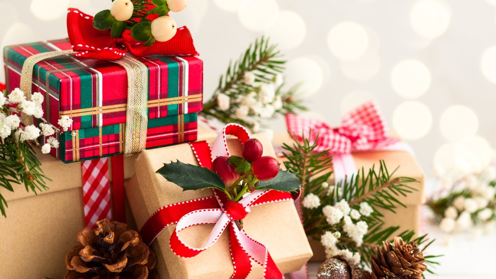 A pile of gifts wrapped in red, green, white and gold bows.