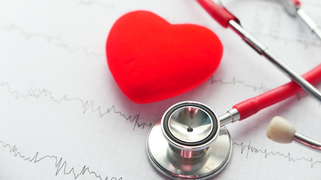 A stethoscope sits on top of a medical chart. A red felt heart shape is next to it.