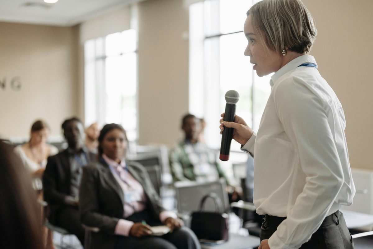A woman speaks to a group 