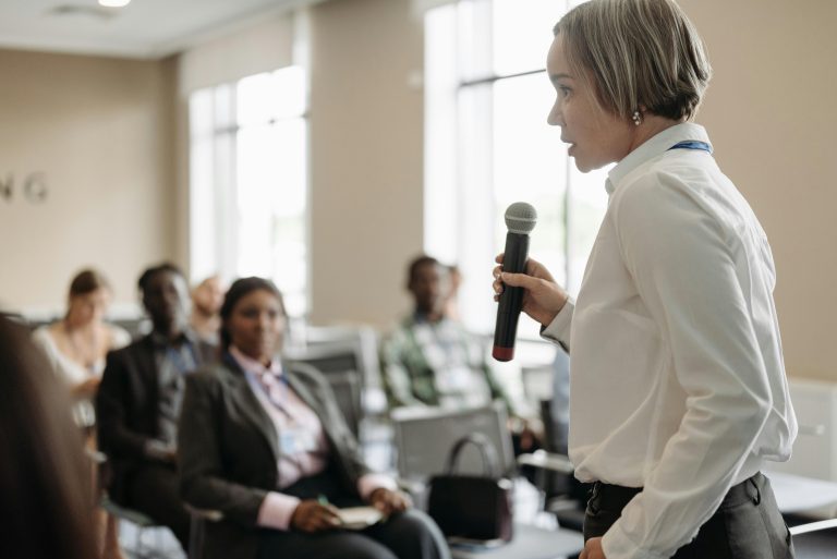 A woman speaks to a group