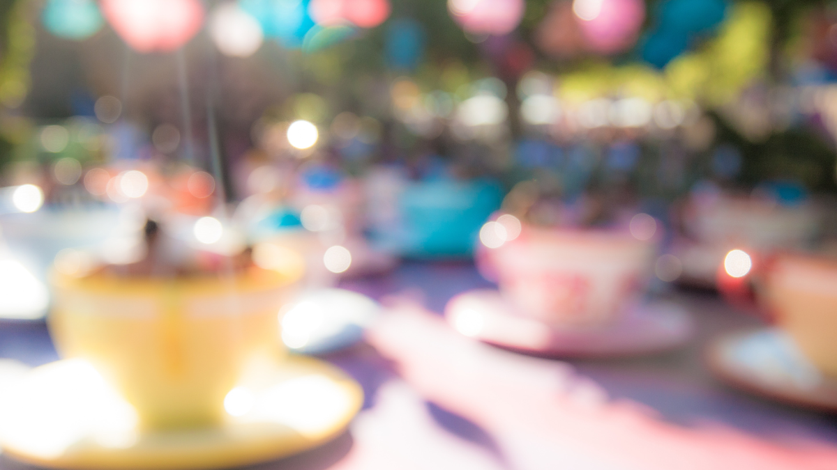 A soft-focused photo of a teacup ride at a fairground.