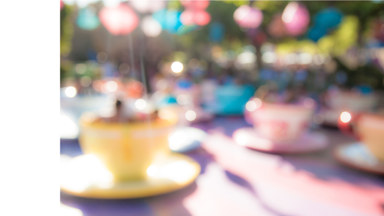 There is a softly focused photo of a tea cup fairground ride.