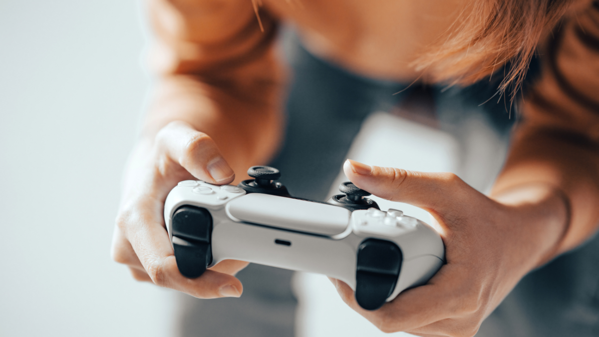 Close up of a woman's hands holding a gaming console