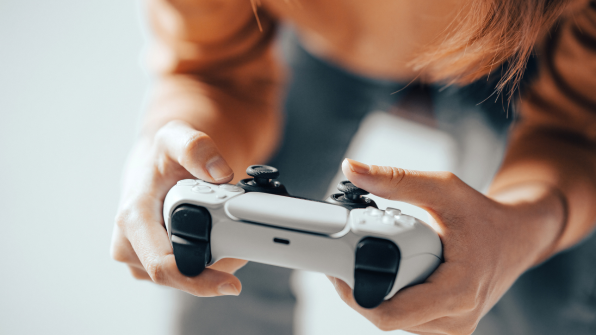 Close-up. The gamer holds a gamepad in his hands. Plays video