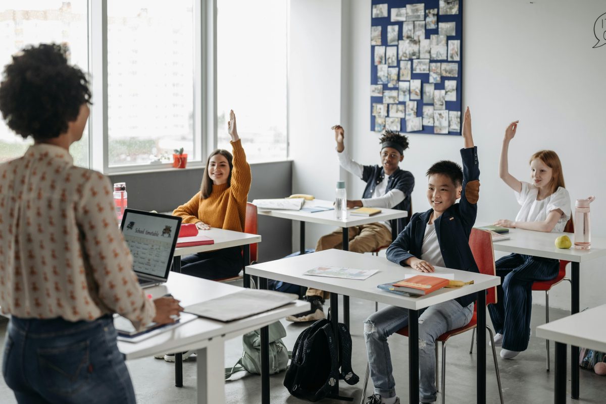 Children interacting with their teacher in class