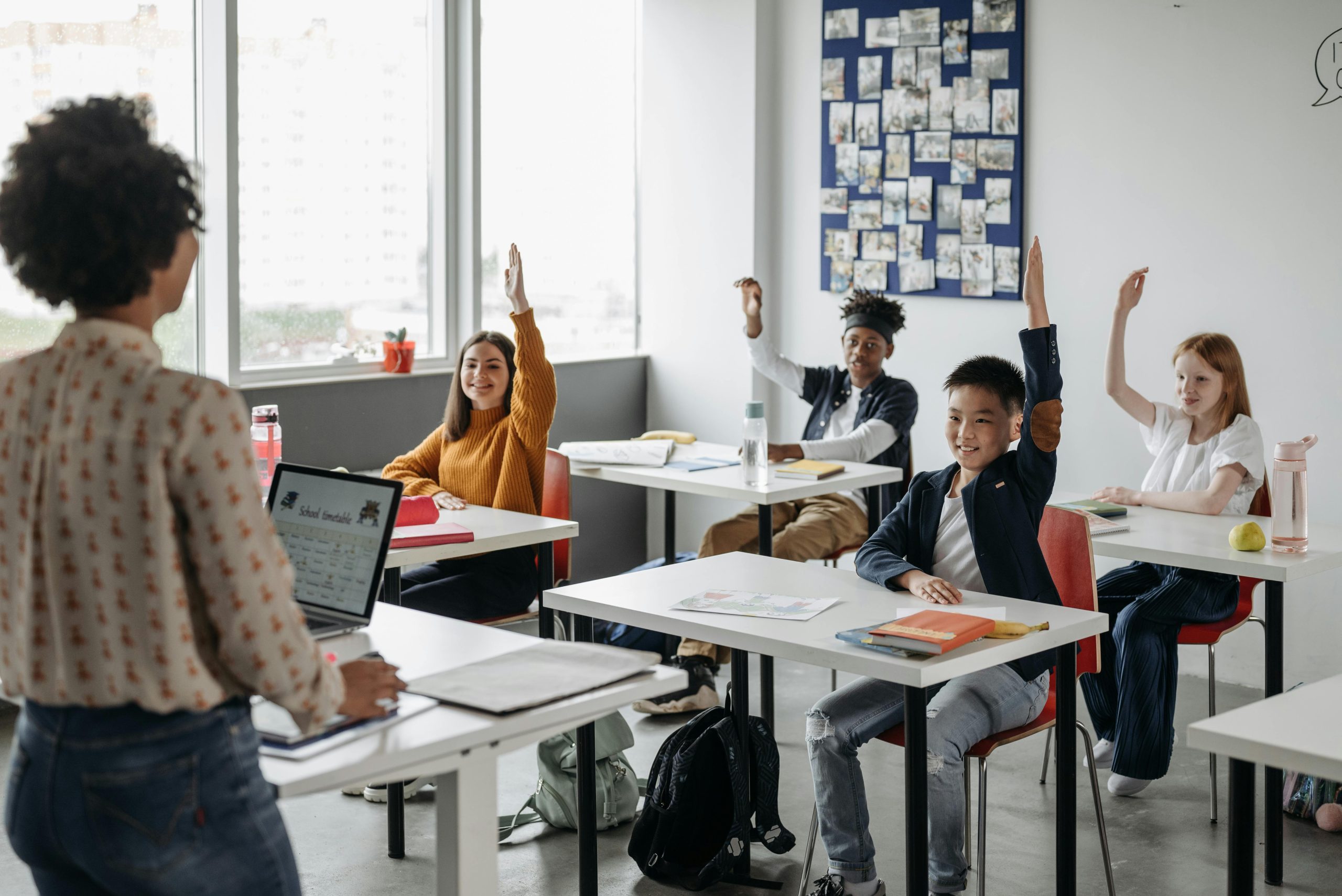 Children interacting with their teacher in class
