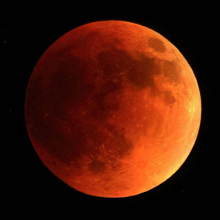 Orange moon on black background