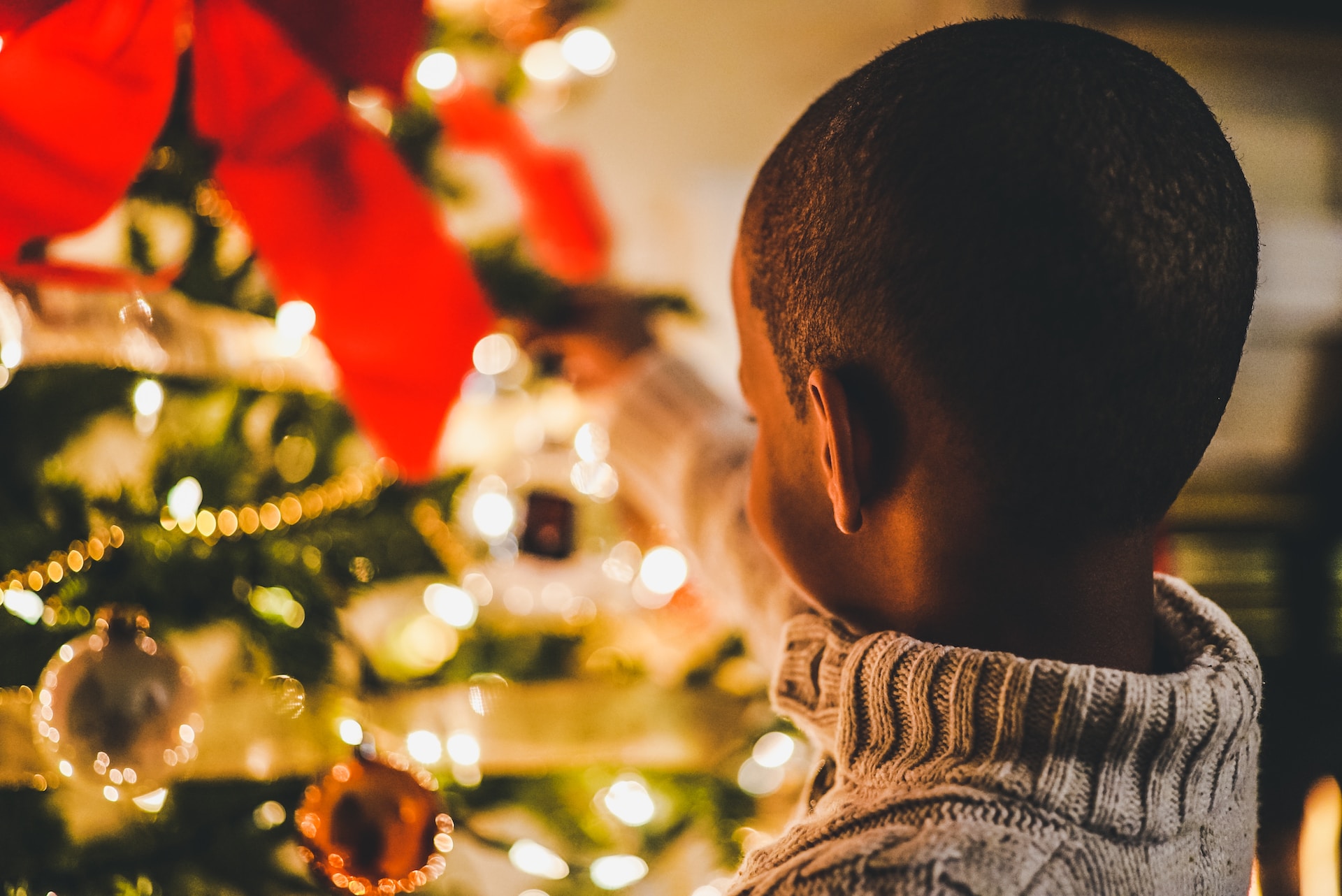 Child next to decorated tree