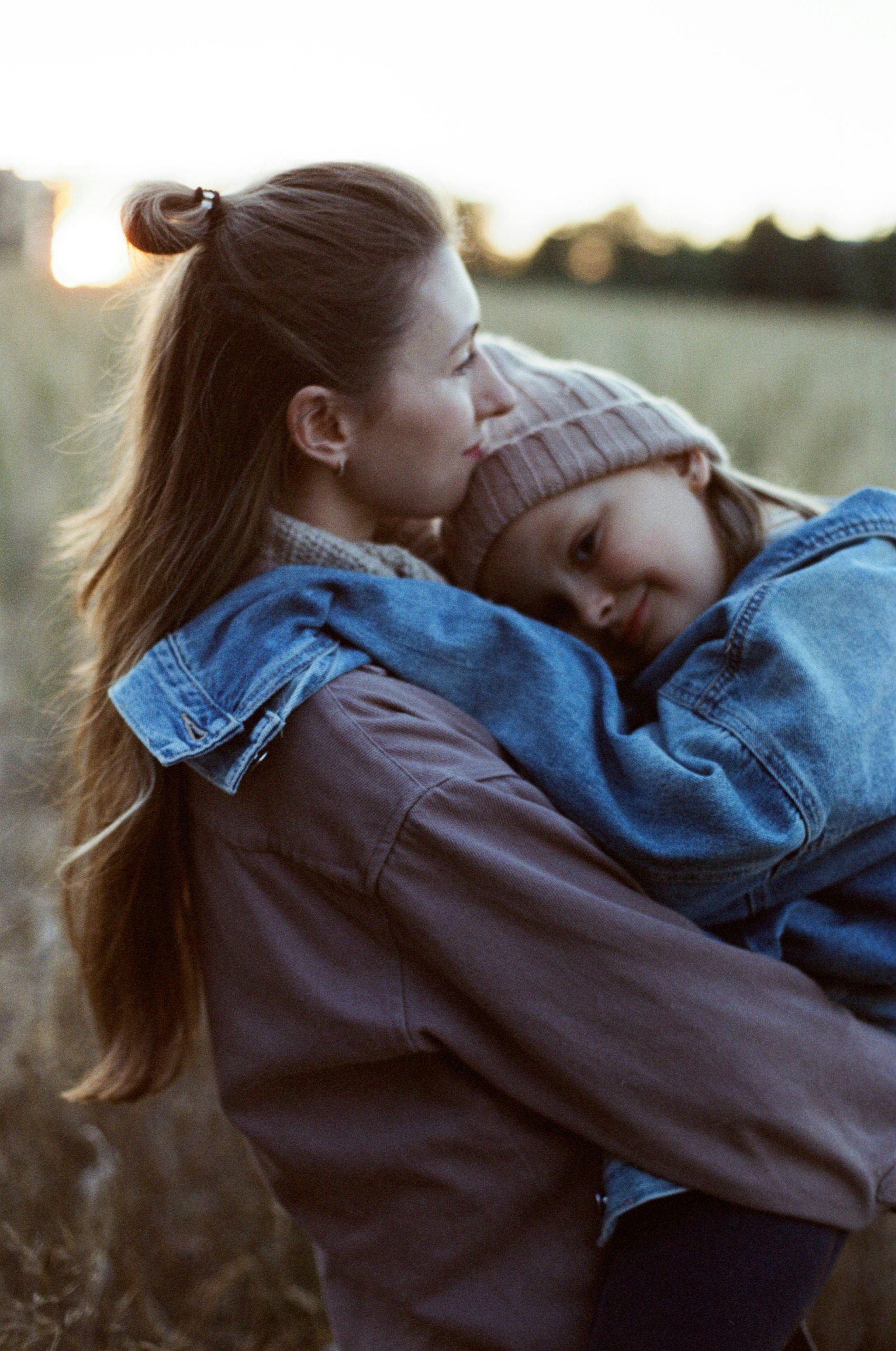 A mother cuddles her daughter
