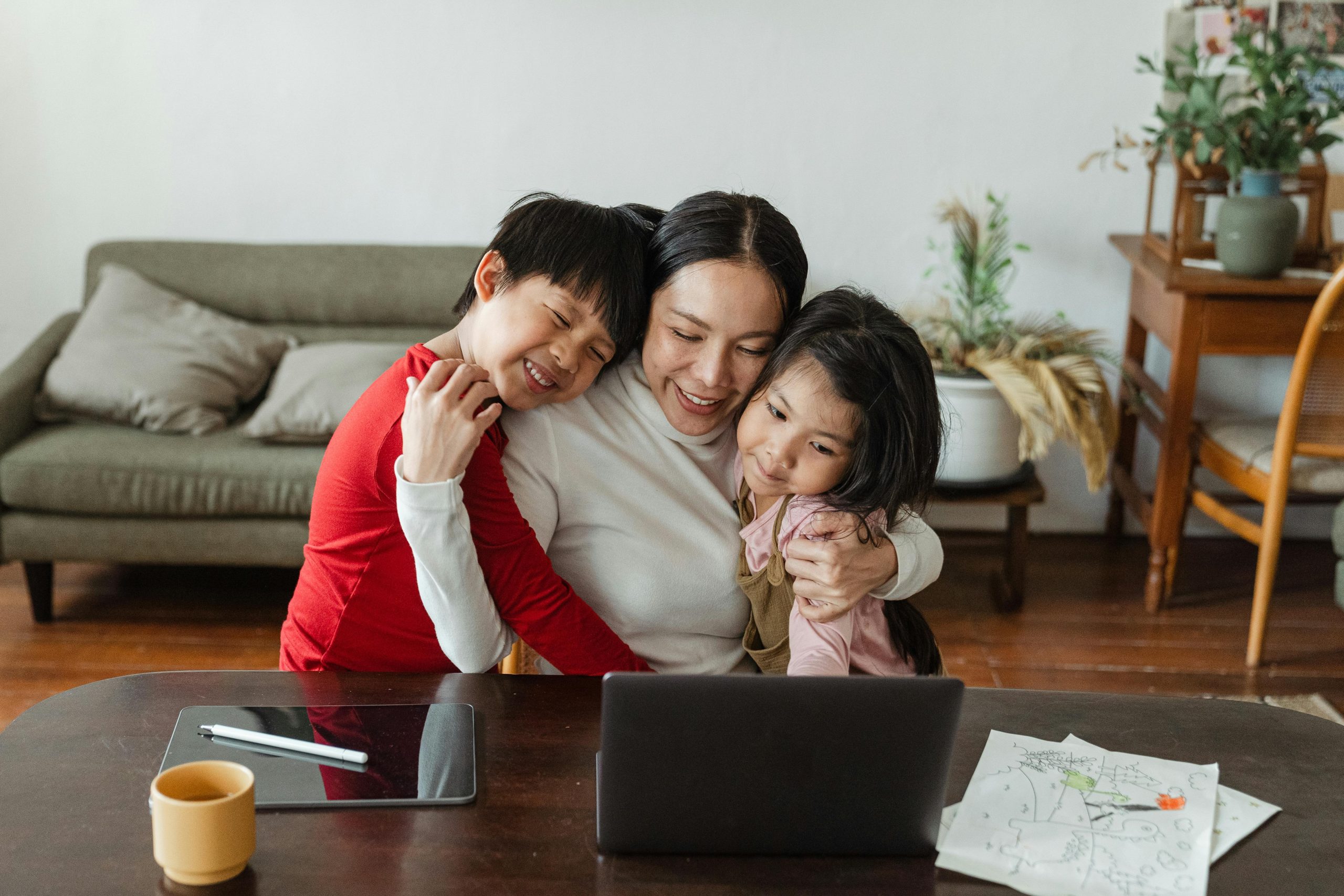 A mother hugs her two children
