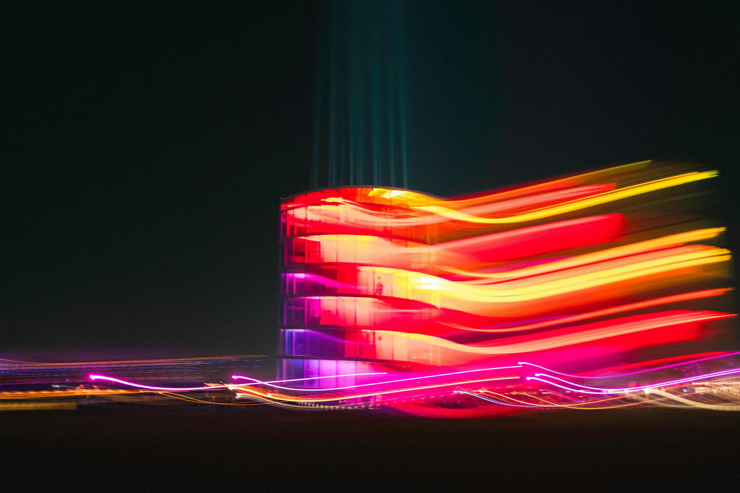 Colourful lights over building at night