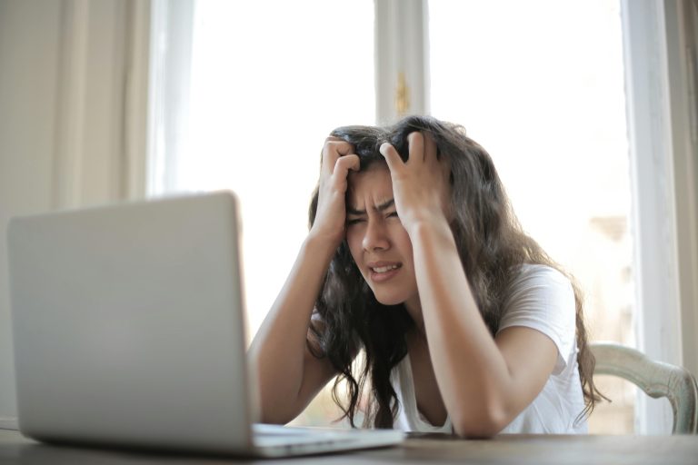 A woman sits at her desk, showing frustration