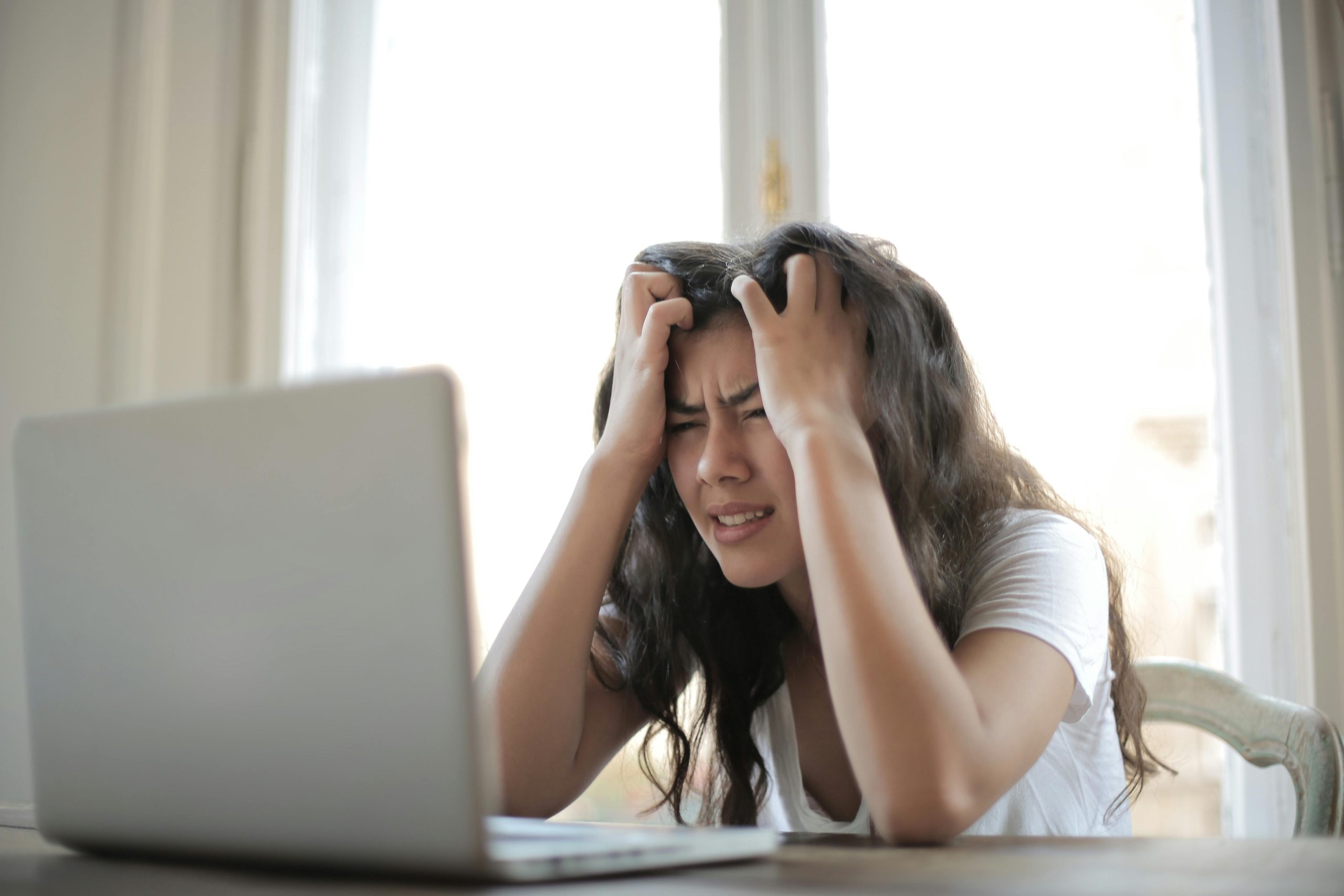 A woman sits at her desk, showing frustration