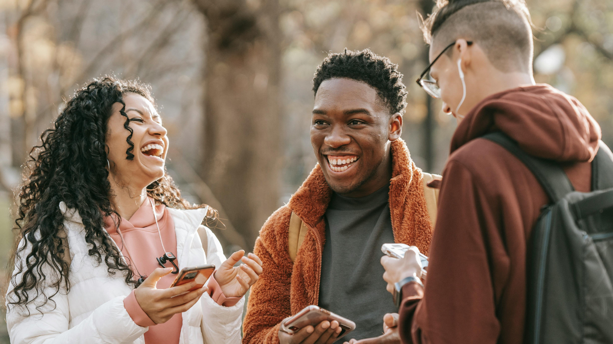 A photo of three friends, chatting.