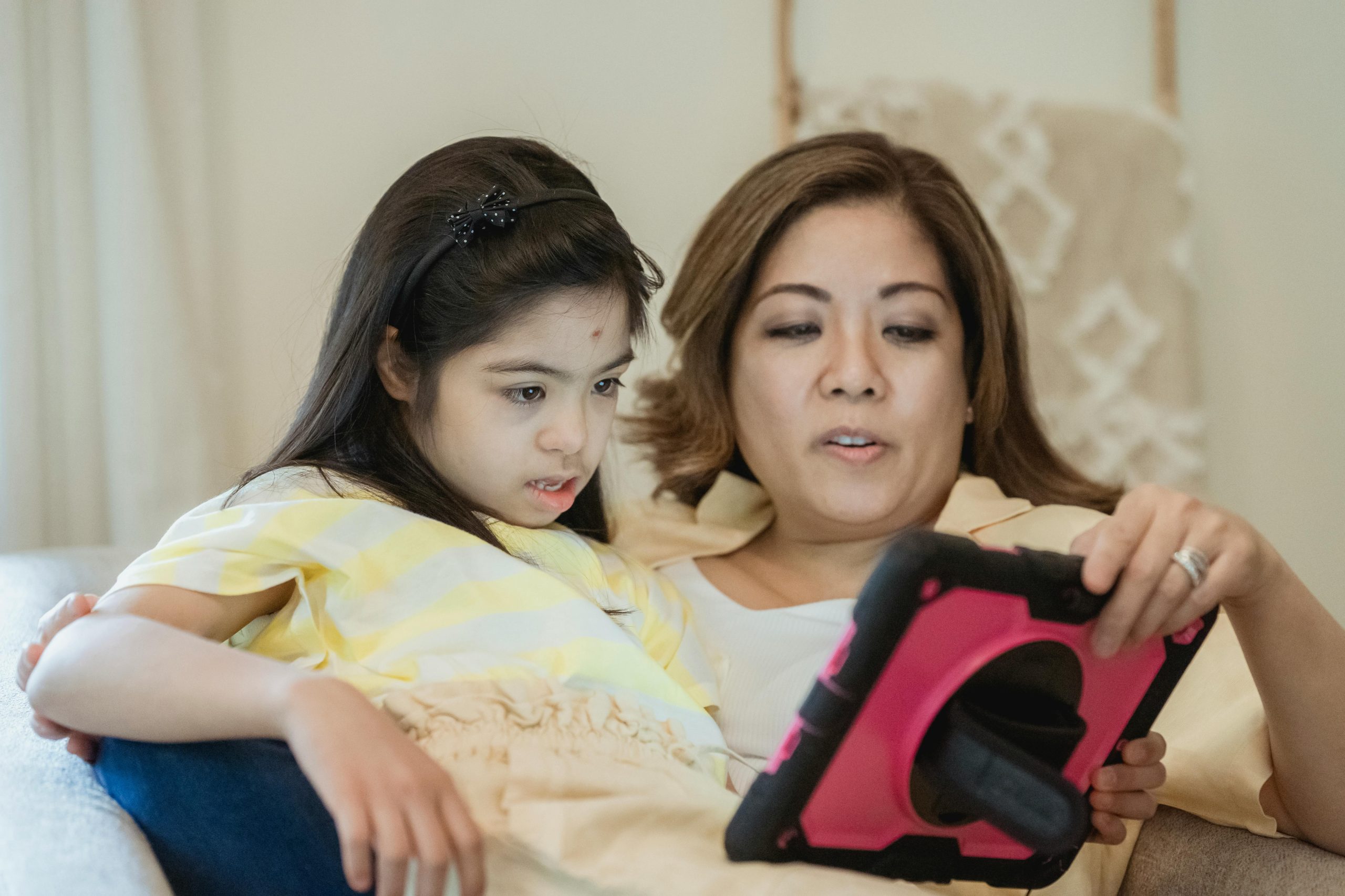 A mother using an AAC device with her child