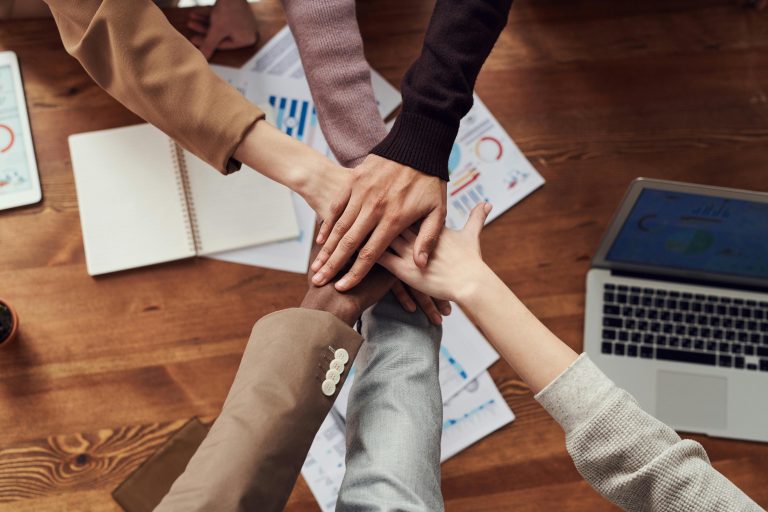 A group of people joining hands